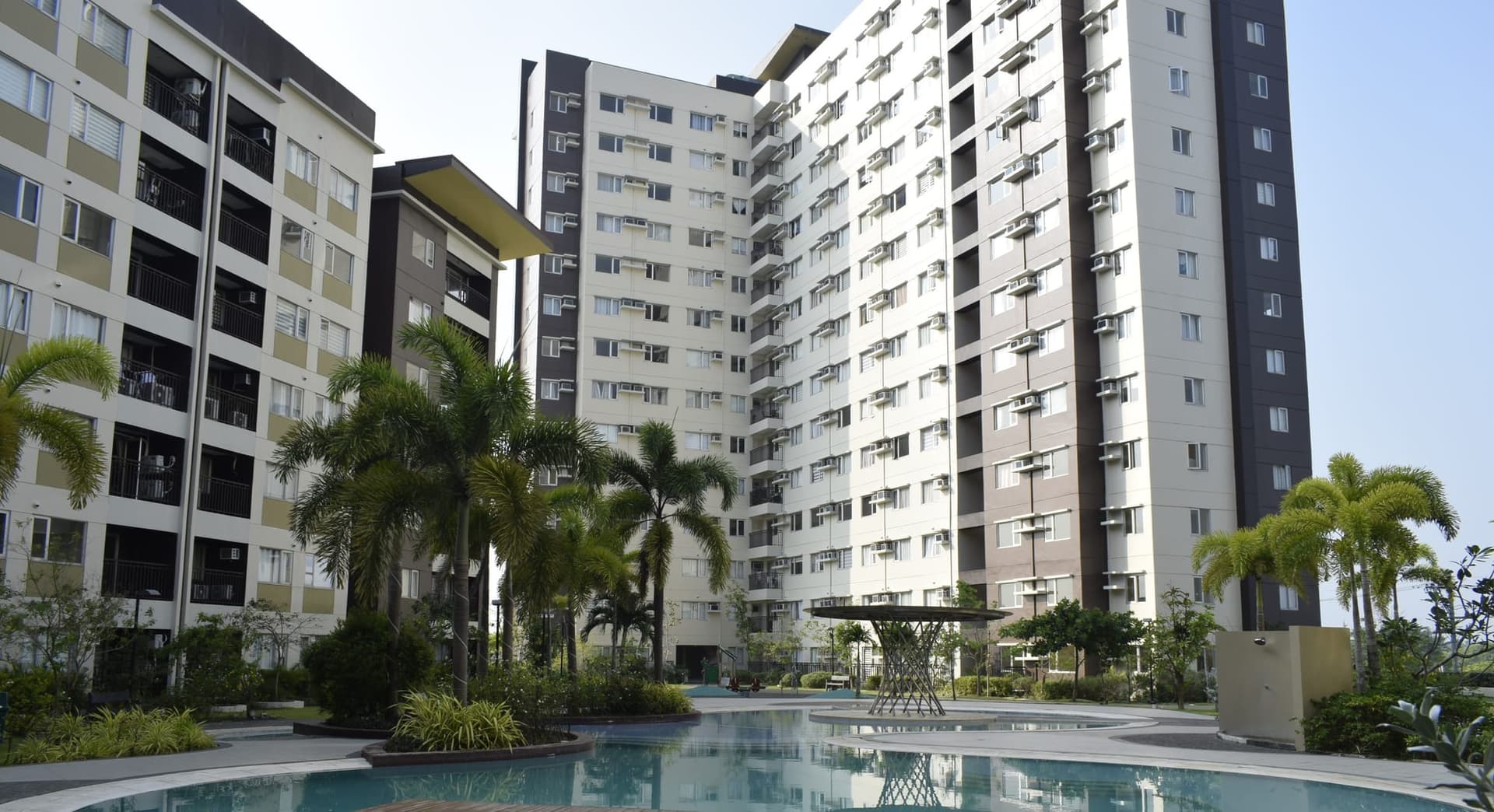 The Avida Towers Atria residential towers beside the pool